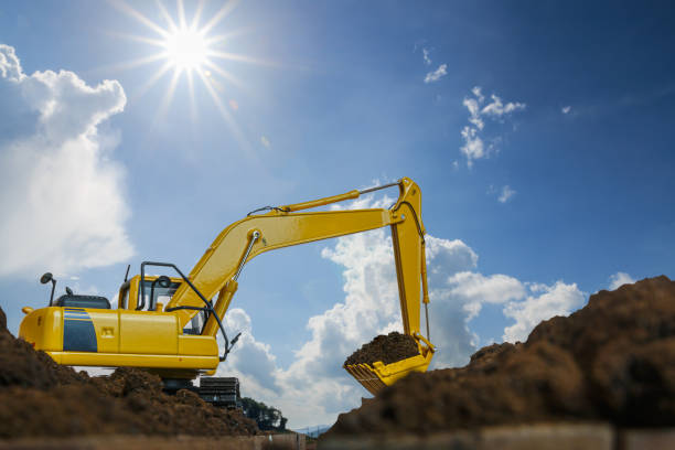 istock Yellow excavators are digging the soil in the construction site . 1474485013