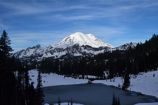 This photo depicts the alpine  Tipsoo Lake with Mount Rainier.  This lake is within Mount Rainier National Park just below Chinook Pass.  The road through the pass is open till the November storms close it for the winter.  This area of the park can receive up to 300 - 400