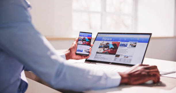 istock Watching News On Screen. Reading Newspaper Website 1474486930