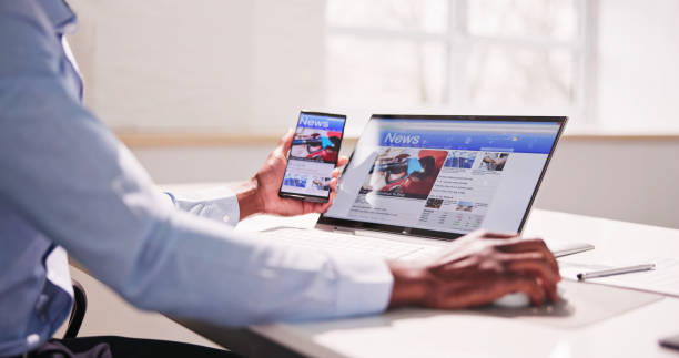 istock Watching News On Screen. Reading Newspaper Website 1474486935