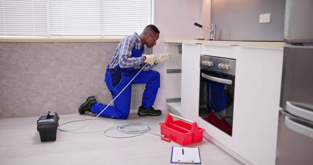 istock Young Male Plumber Cleaning Clogged Sink Pipe 1474487069