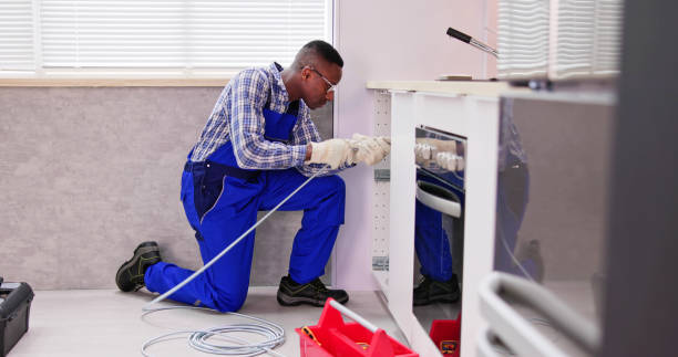 istock Young Male Plumber Cleaning Clogged Sink Pipe 1474487093