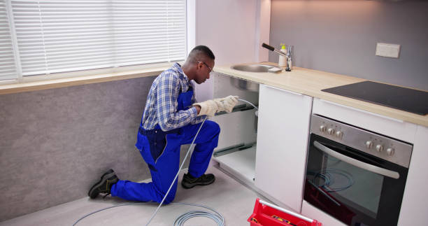 istock Young Male Plumber Cleaning Clogged Sink Pipe 1474487101