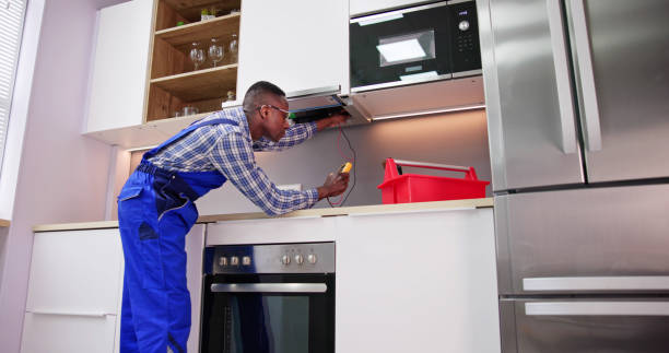 istock Young Repairman Repairing Kitchen Extractor Filter 1474487122