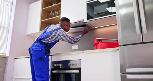 istock Young Repairman Repairing Kitchen Extractor Filter 1474487147