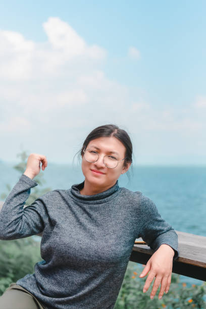istock Woman (LGBTQ) posing at sea viewpoint with happy 1474493397