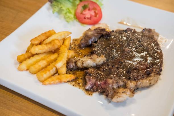 istock Medium rare meat on plate with sauce and fries 1474493528