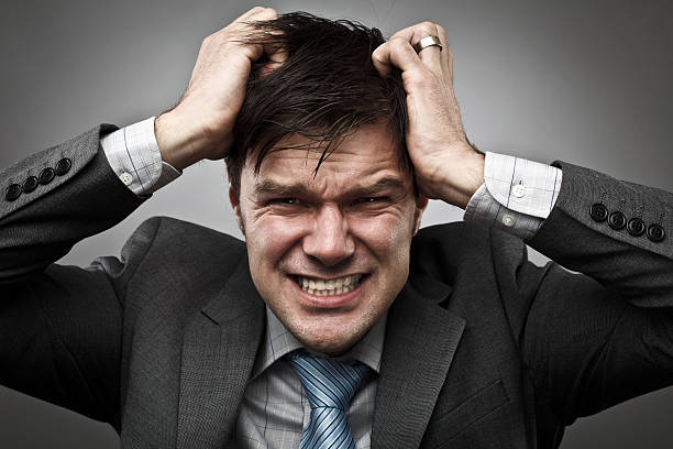 Businessman pulling his hair stock photo