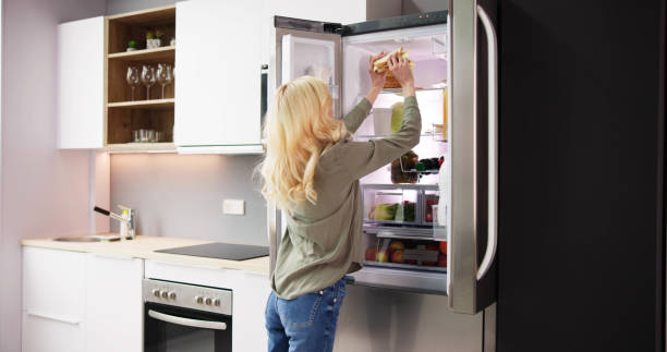 istock Young Woman Eating Sandwich In Front 1474498388