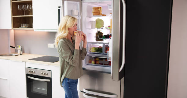 istock Hungry Woman Eating Cheese Sandwich 1474498389