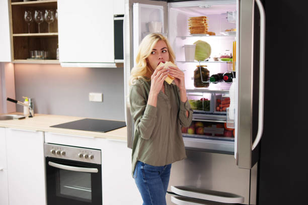 istock Hungry Woman Eating Cheese Sandwich 1474498395