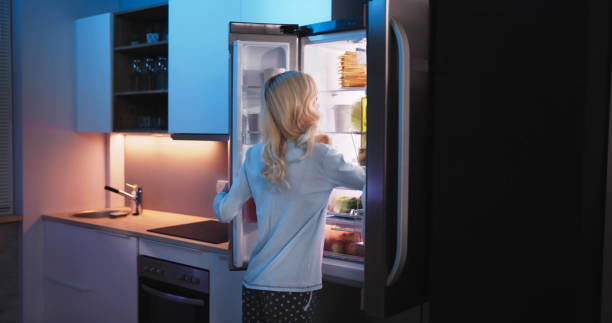istock Women Looking For Food Inside Fridge 1474498403