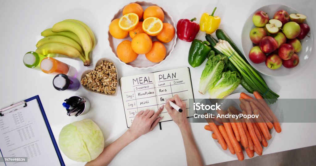 Female Dietitian Doctor Writing Meal Plan Female Dietitian Doctor Writing Meal Plan In Goals Healthy Eating Stock Photo