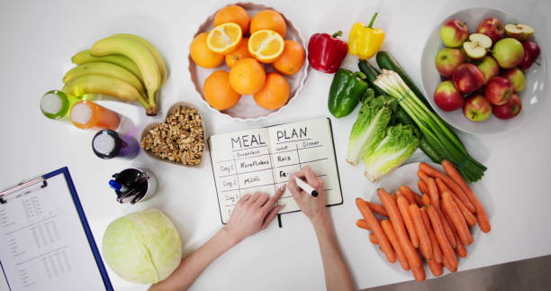Female Dietitian Doctor Writing Meal Plan stock photo