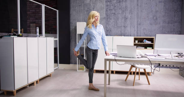 istock Yoga Workout In Office Behind Business Computer 1474498580