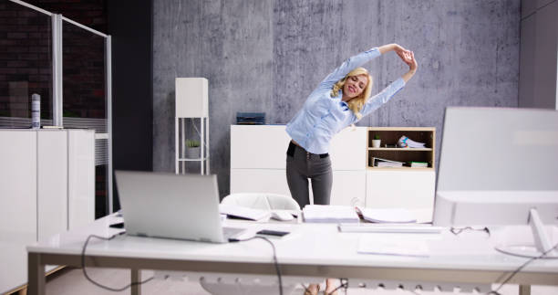 istock Arms Stretch Exercise Standing Near Desk 1474498581