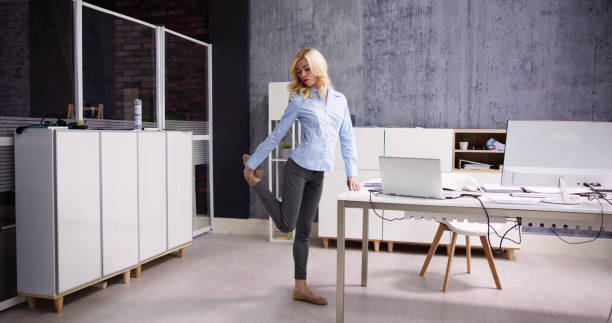 istock Yoga Workout In Office Behind Business Computer 1474498592