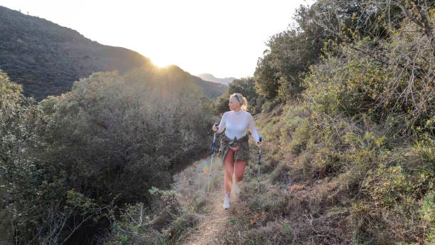 istock Mature woman walks along narrow path in hilly setting 1474504975