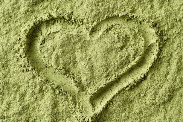 istock Heart shape drawn in barley grass powder 1474506202