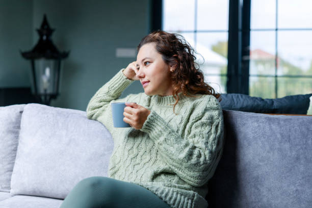 istock Young woman drinking a cup of coffee 1474506641