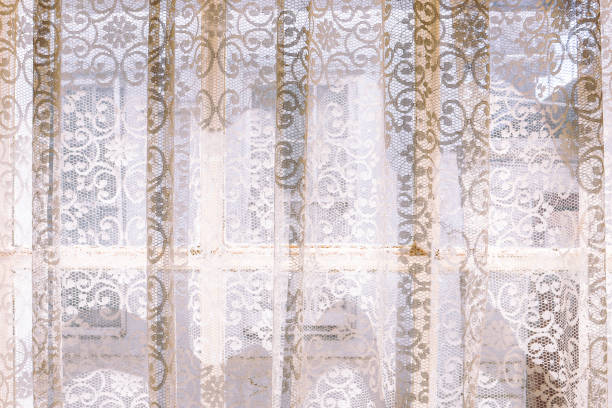istock vintage lace curtains and light shining through window 1474506998