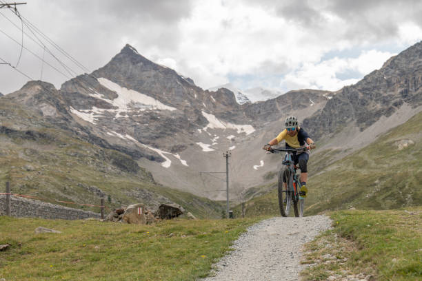 istock Mountain biker descends trail in the Alps 1474507076