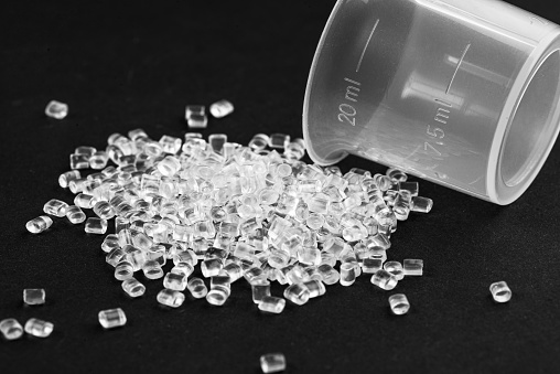 Transparent Plastic in granules. Polymer pellets on black