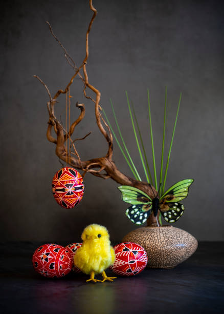 hand painted red sorbian easter eggs in low key with ikebana