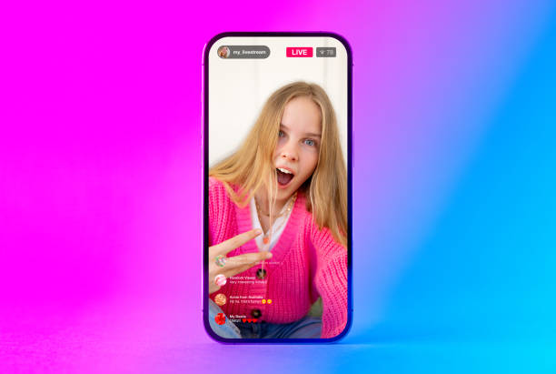 istock Mobile phone with sample social media live video stream on the screen 1474509337