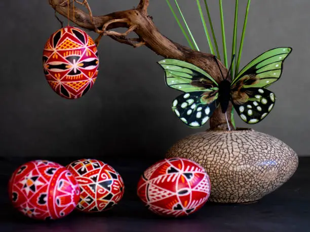 hand painted red sorbian easter eggs in low key with ikebana