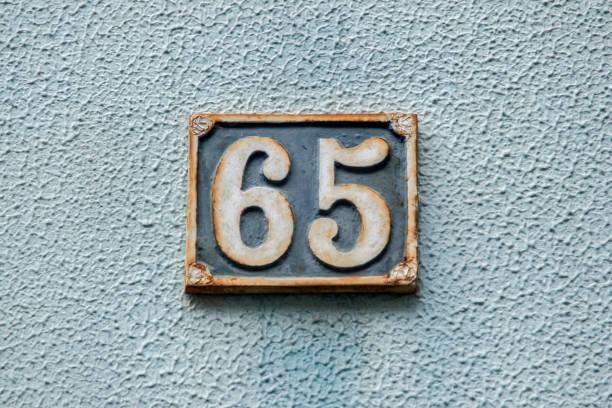istock Old retro cast iron plate number 65 1474510704