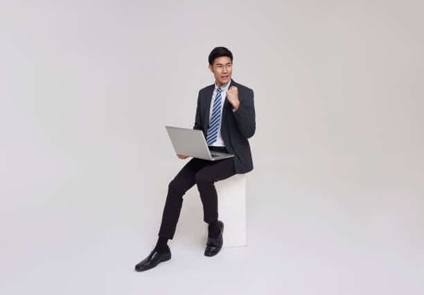 Free Stock Photo of Man Sitting on Ledge Using Laptop Computer ...