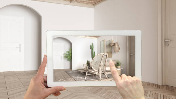 istock Augmented reality concept. Hand holding tablet with AR application used to simulate furniture and design products in empty interior with parquet, modern living room with sofa 1474516513
