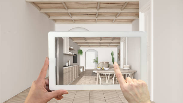 istock Augmented reality concept. Hand holding tablet with AR application used to simulate furniture and design products in empty interior with parquet, modern kitchen, living, dining room 1474516514