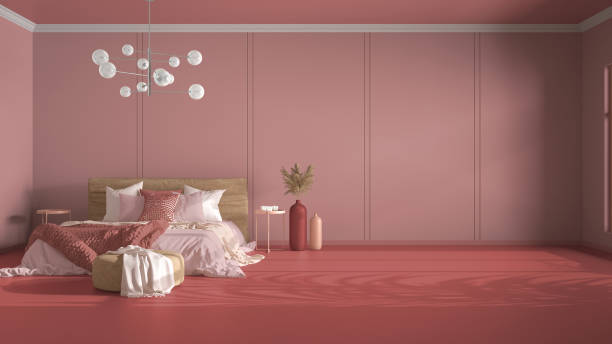 istock Classic pink background with copy space: empty bedroom, double bed with blanket, linens and pillows, pouf and decors. Glass modern chandelier. Home and hotel interior design concept 1474516537