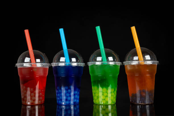istock Various Bubble Tea in a plastic cups with drink straws on black background. Take away drinks concept. 1474519993