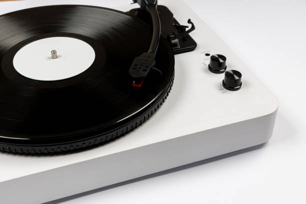 istock Vinyl turntable with vinyl plate on white background. Modern gramophone record player. Retro sound technology to play music 1474520160