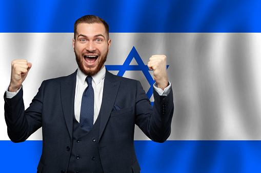 Izraeli happy businessman on the background of flag of Izrael Business, education, degree and citizenship concept
