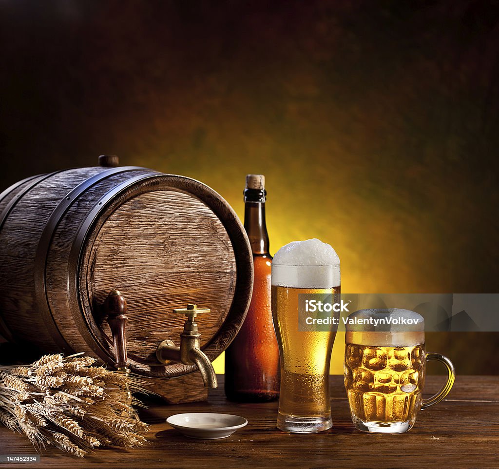 Beer barrel with glasses Beer barrel with beer glasses on a wooden table. The dark background. Alcohol - Drink Stock Photo