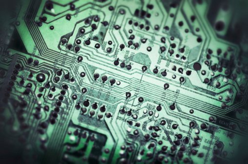 Closeup on computer circuit board; tilt shift and toned image.