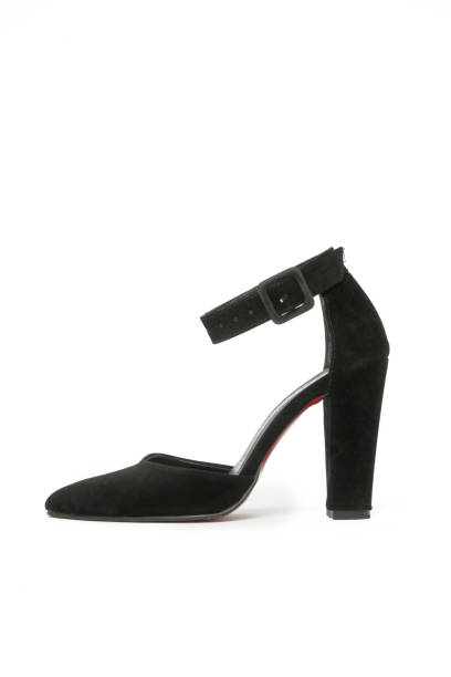 istock Black women's pointed toe pumps with block high heels and ankle strap, studio shot isolated on white background 1474524442