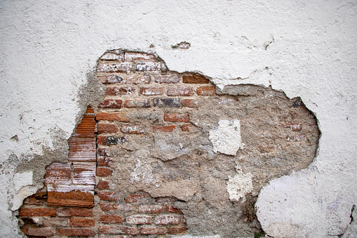 Deteriorated old orange brick wall