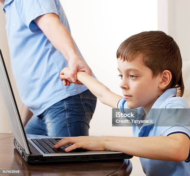 Father Dragging Son From The Computer Stock Photo - Download Image Now - Child, Dragging, Parent