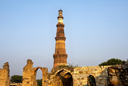 New Delhi, India, November 21, 2015: View of the Qutub Minar - a victory tower in the Qutub complex, a UNESCO World Heritage Site in the Mehrauli area. The height of Qutub Minar is 72.5 meters.