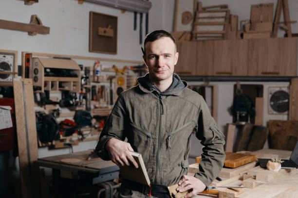 istock Portrait Carpenter man wood worker looking camera smiling. 1474538931