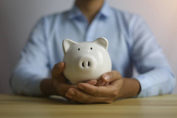 istock saving money in a white piggy bank 1474545486