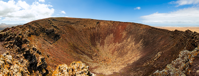 Low level panoramic view of the deep volcanic crater of Calderon Hondo volcano near Corralejo in Fuerteventura Spain