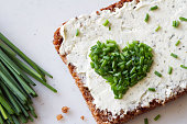 Sandwich with cream cheese and heart-shaped chives, concept