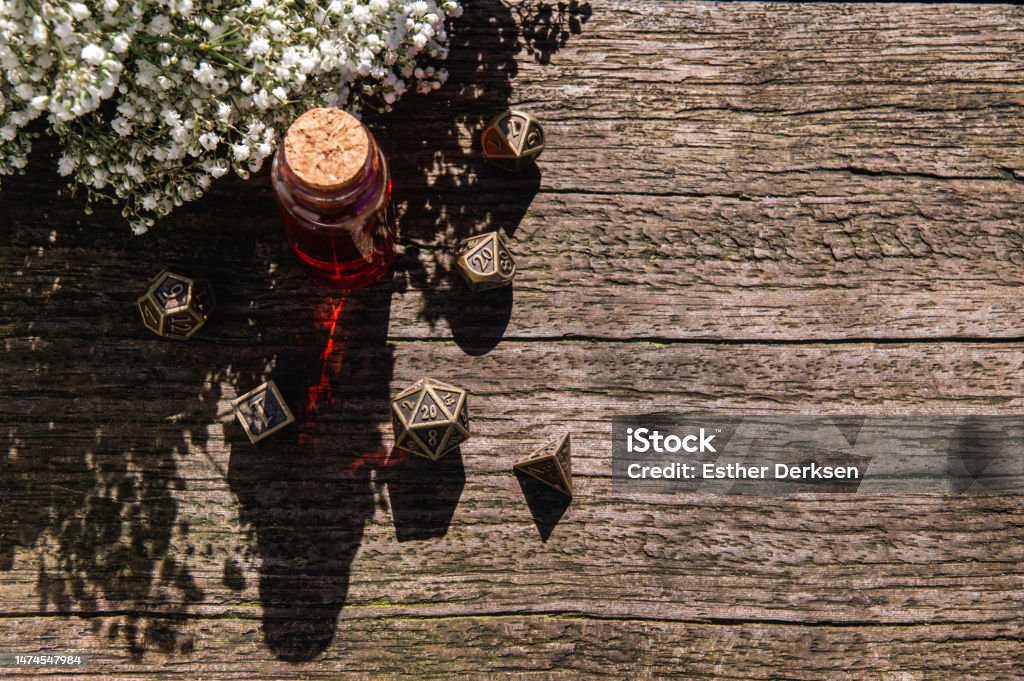 An Overhead Shot of Bronze Role Playing Dice Set An Overhead Shot of Bronze Role Playing Dice Set on a woodentable Group Of Objects Stock Photo