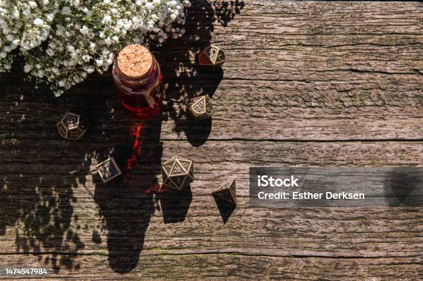 An Overhead Shot Of Bronze Role Playing Dice Set Stock Photo - Download Image Now - Group Of Objects, Table, Adventure